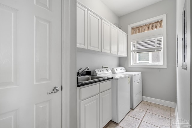 laundry area with washer and dryer, sink, light tile patterned floors, and cabinets