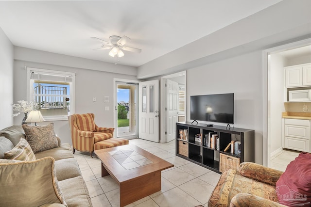 living room featuring light tile patterned floors, plenty of natural light, and ceiling fan