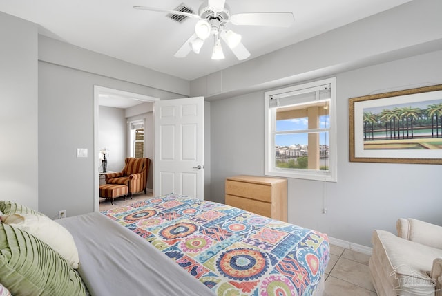 tiled bedroom featuring ceiling fan