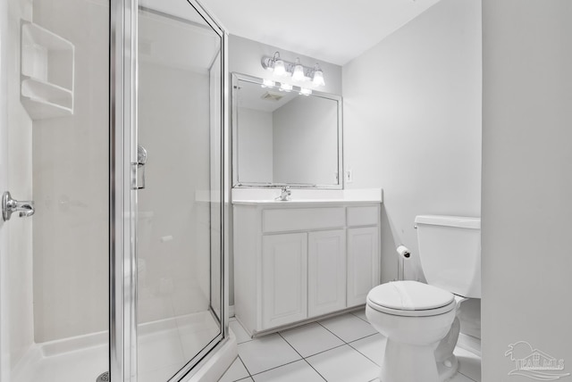 bathroom with tile patterned floors, vanity, toilet, and walk in shower