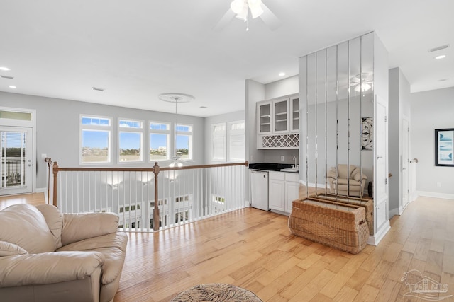 living room featuring light hardwood / wood-style flooring and sink