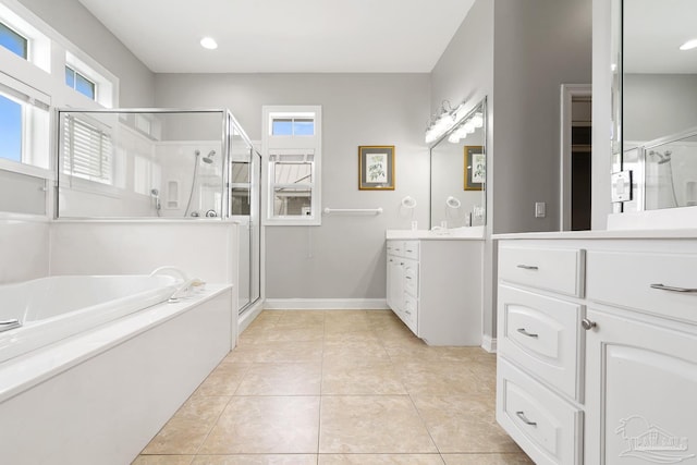 bathroom with tile patterned flooring, shower with separate bathtub, and vanity