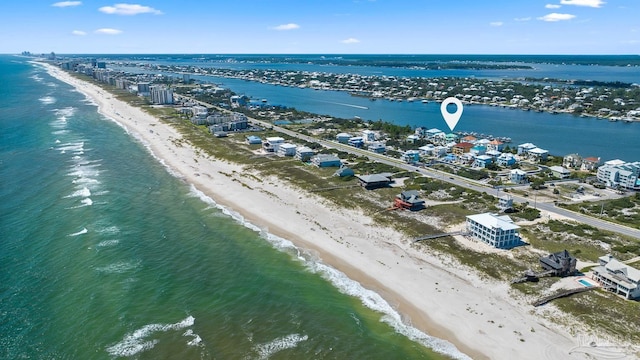 drone / aerial view featuring a beach view and a water view