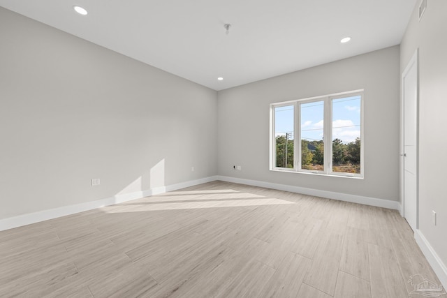 empty room with light hardwood / wood-style flooring