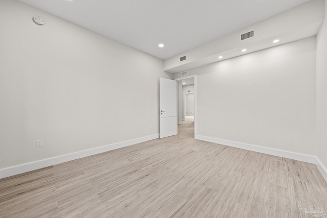 spare room with light hardwood / wood-style flooring