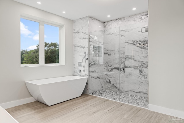 bathroom featuring hardwood / wood-style floors and independent shower and bath