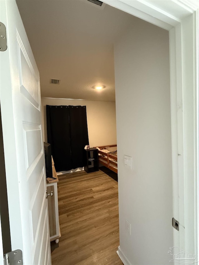 6312 June Bug Dr, Milton, FL 32583 - hall with visible vents and wood finished floors