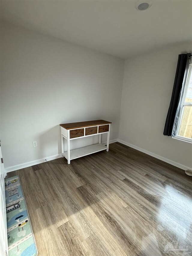 6312 June Bug Dr, Milton, FL 32583 - unfurnished bedroom featuring wood finished floors and baseboards