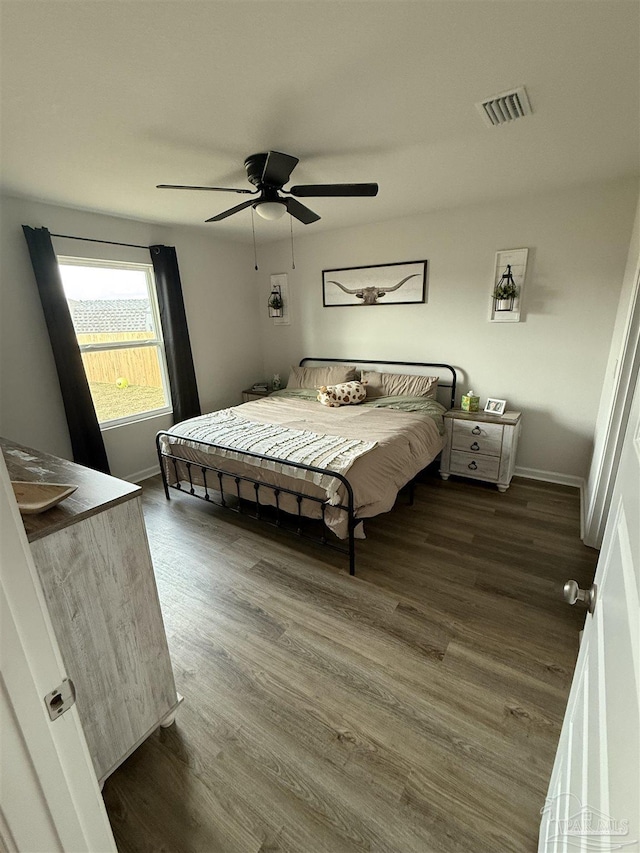 6312 June Bug Dr, Milton, FL 32583 - bedroom with baseboards, visible vents, and wood finished floors