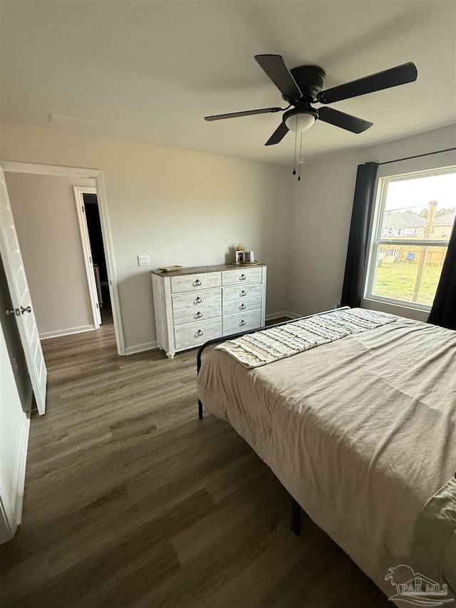6312 June Bug Dr, Milton, FL 32583 - bedroom featuring baseboards, a ceiling fan, and dark wood-style flooring