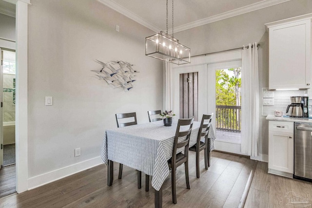 dining space with an inviting chandelier, dark wood-type flooring, and ornamental molding