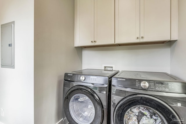 laundry area featuring cabinets, electric panel, and washer and dryer