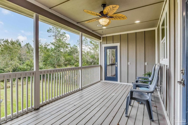 unfurnished sunroom featuring ceiling fan