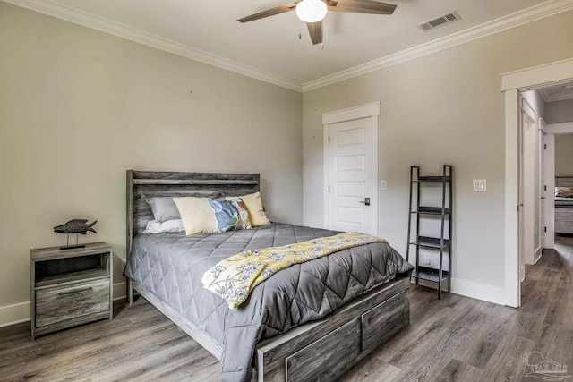 bedroom featuring hardwood / wood-style flooring, ornamental molding, and ceiling fan