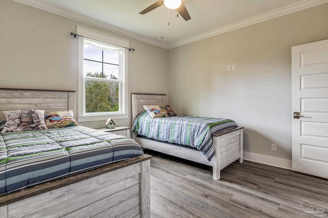 bedroom with crown molding, ceiling fan, and hardwood / wood-style flooring