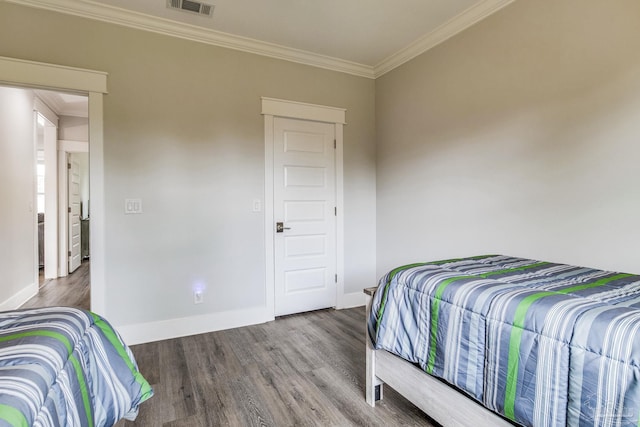 bedroom featuring wood-type flooring and ornamental molding