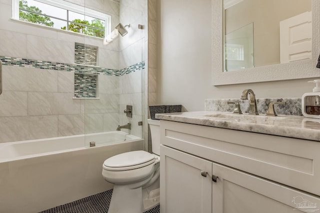 full bathroom with tiled shower / bath combo, vanity, and toilet