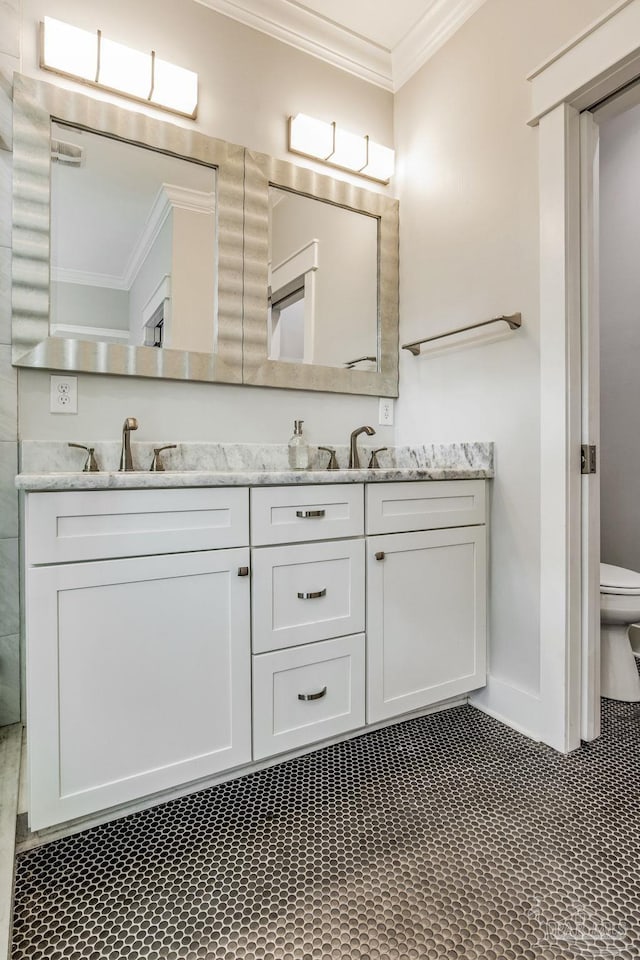 bathroom featuring crown molding, vanity, and toilet