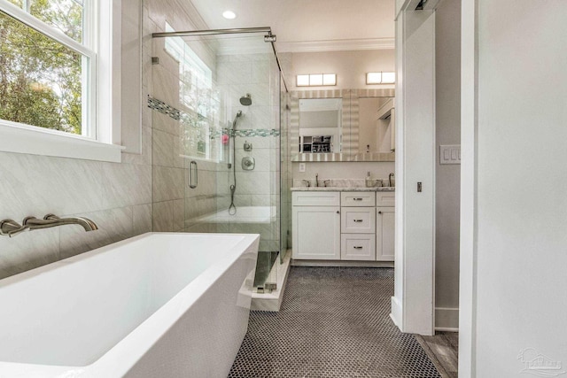 bathroom featuring vanity, crown molding, and shower with separate bathtub