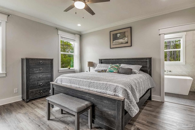 bedroom featuring ceiling fan, ornamental molding, and dark hardwood / wood-style flooring