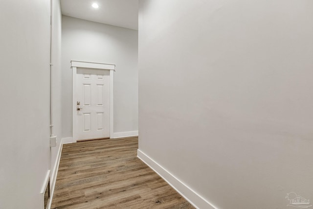 hallway with hardwood / wood-style floors