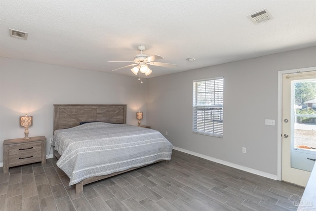bedroom with visible vents, baseboards, and wood finished floors