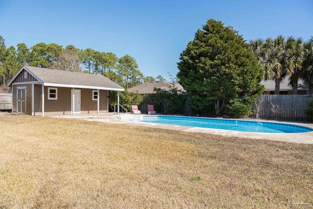 view of pool featuring a patio area, a lawn, an outdoor structure, fence, and a fenced in pool