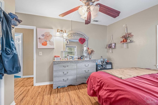 bedroom with ceiling fan and light hardwood / wood-style floors