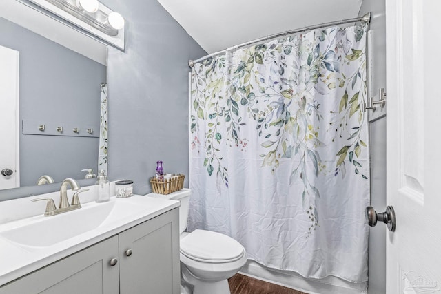 full bathroom featuring shower / bathtub combination with curtain, vanity, toilet, and hardwood / wood-style floors