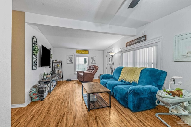 living room with hardwood / wood-style flooring and beamed ceiling