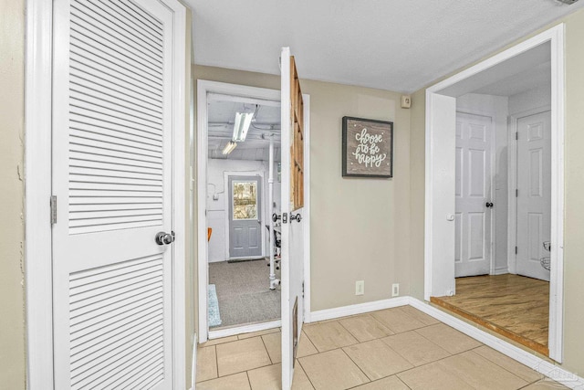 hall featuring light tile patterned flooring