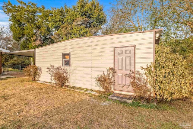 view of outbuilding with a lawn