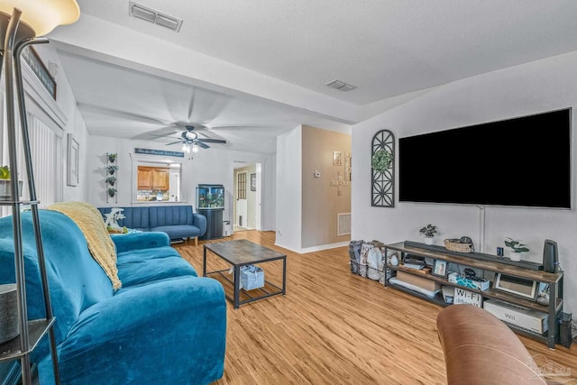 living room featuring hardwood / wood-style flooring and ceiling fan