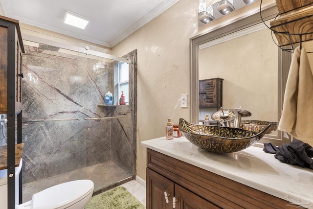 bathroom with ornamental molding, toilet, a shower with shower door, and vanity