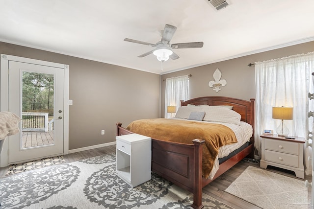 bedroom featuring ornamental molding, wood-type flooring, and access to exterior