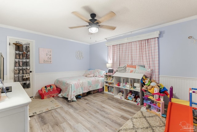 bedroom featuring crown molding, ceiling fan, and light wood-type flooring