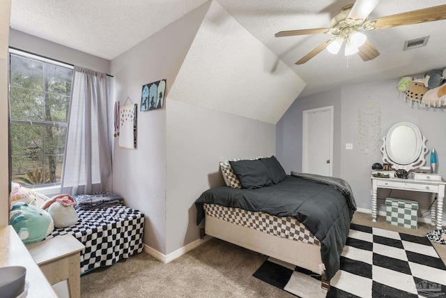 carpeted bedroom featuring lofted ceiling, ceiling fan, and a textured ceiling