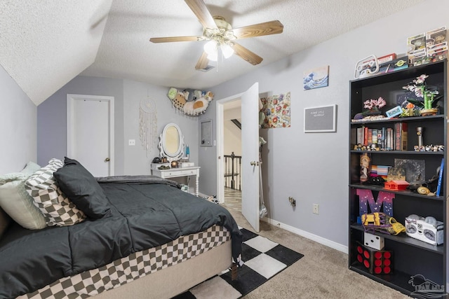 bedroom featuring ceiling fan, light colored carpet, and a textured ceiling