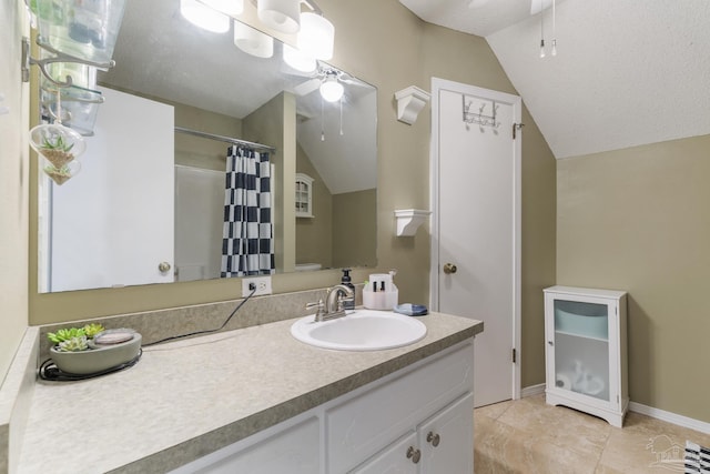 bathroom featuring vanity, vaulted ceiling, ceiling fan, and toilet