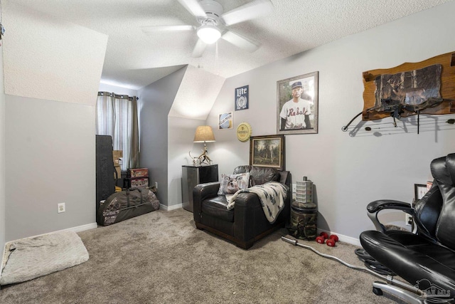 sitting room with vaulted ceiling, ceiling fan, carpet floors, and a textured ceiling