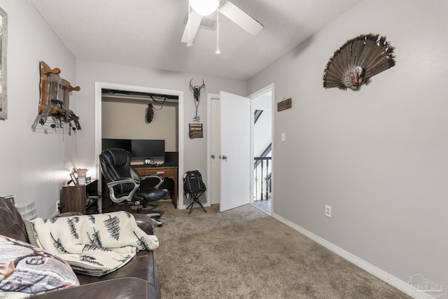 office with ceiling fan, light carpet, and a textured ceiling