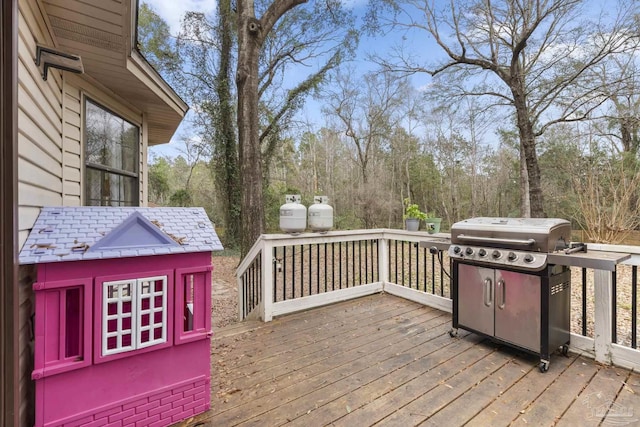 wooden terrace featuring a grill