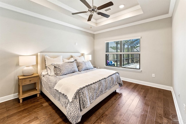 7956 Huntington Creek Ln, Pensacola, FL 32526 - bedroom featuring a tray ceiling, crown molding, baseboards, and dark wood-style floors