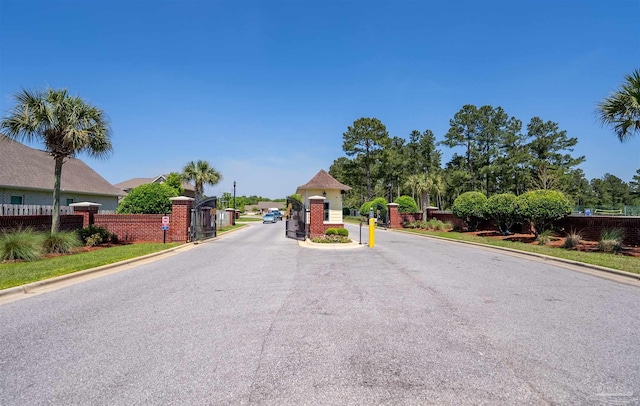 7956 Huntington Creek Ln, Pensacola, FL 32526 - view of road with a gated entry, curbs, and a gate