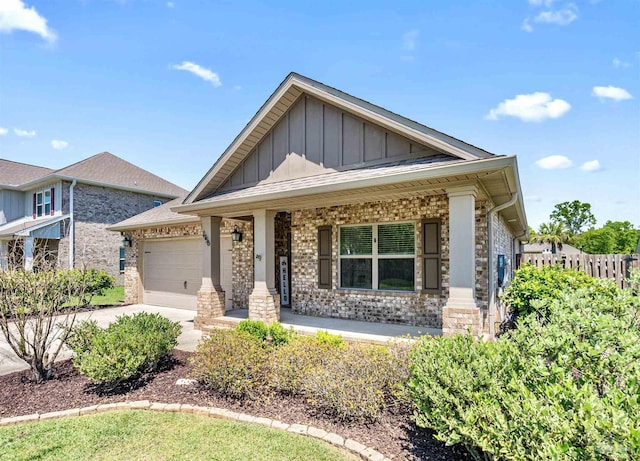 7956 Huntington Creek Ln, Pensacola, FL 32526 - view of front of property featuring a garage, a porch, board and batten siding, and concrete driveway