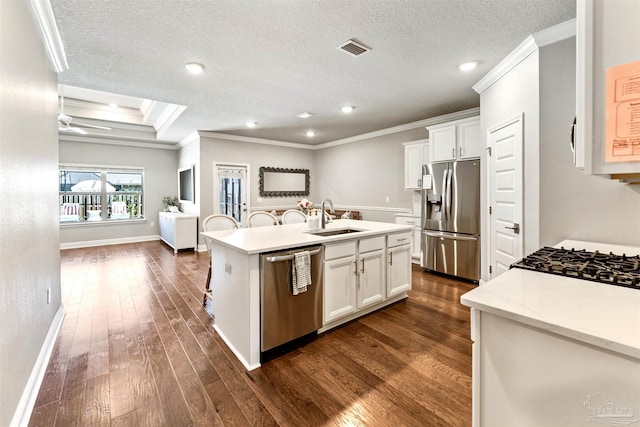7956 Huntington Creek Ln, Pensacola, FL 32526 - kitchen with dark wood-type flooring, ornamental molding, appliances with stainless steel finishes, a sink, and a center island with sink