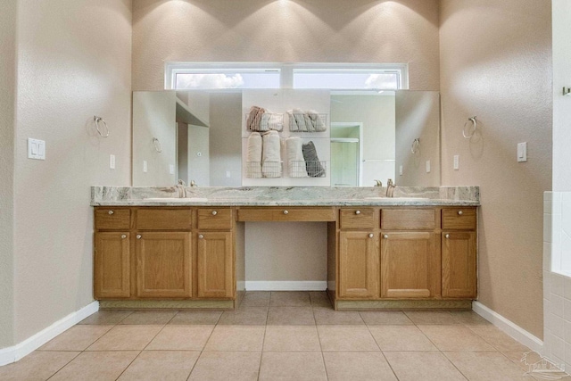 bathroom featuring plenty of natural light, tile patterned floors, and vanity