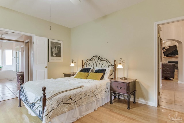 bedroom featuring light hardwood / wood-style floors and connected bathroom