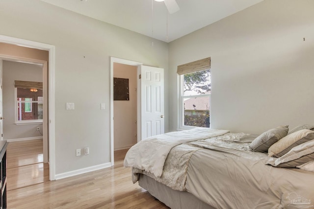 bedroom with ceiling fan and light hardwood / wood-style flooring