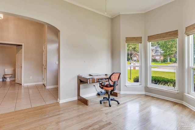 home office featuring ornamental molding and light wood-type flooring